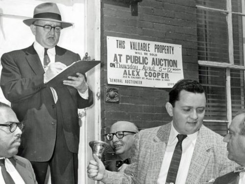 Our founder, Alex Cooper, with his son, Joseph Cooper, at a public auction in 1956.